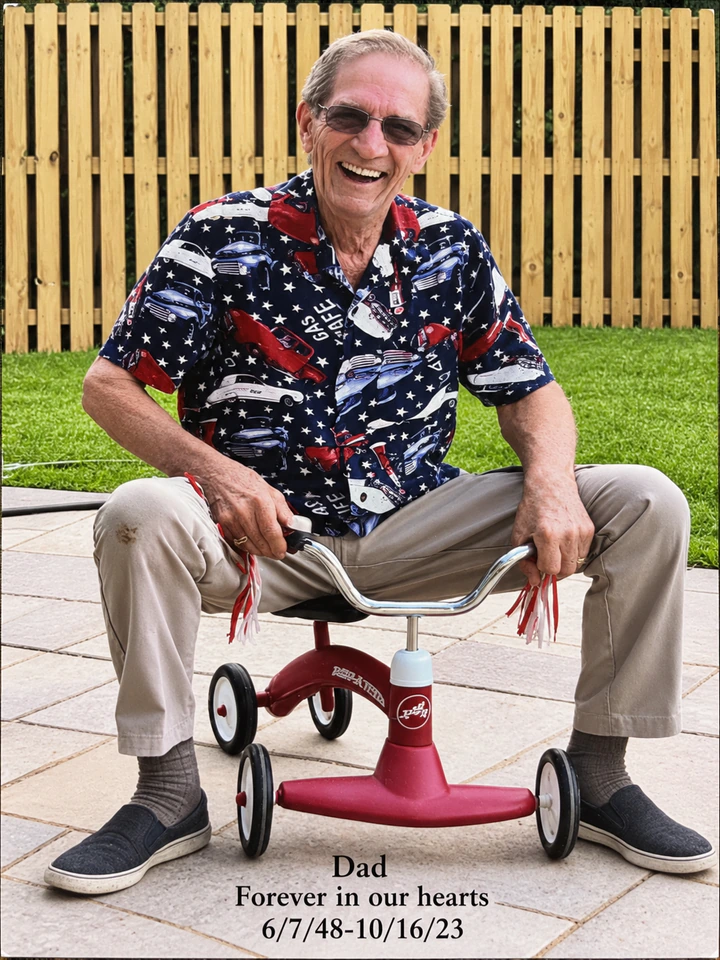 Dad smiling while seated on a red tricycle.